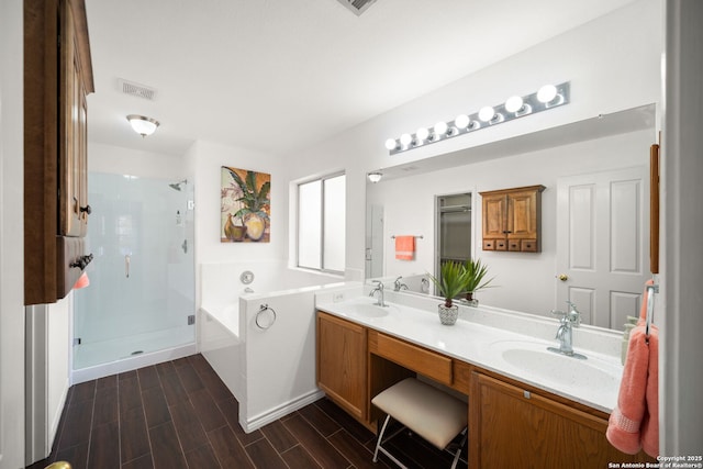 bathroom featuring separate shower and tub and vanity