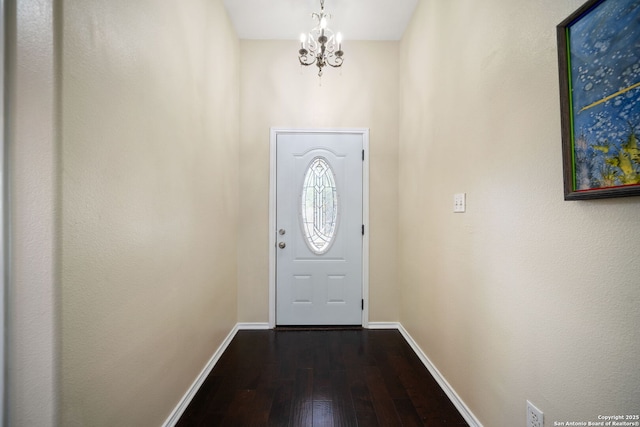 doorway featuring hardwood / wood-style floors and a notable chandelier