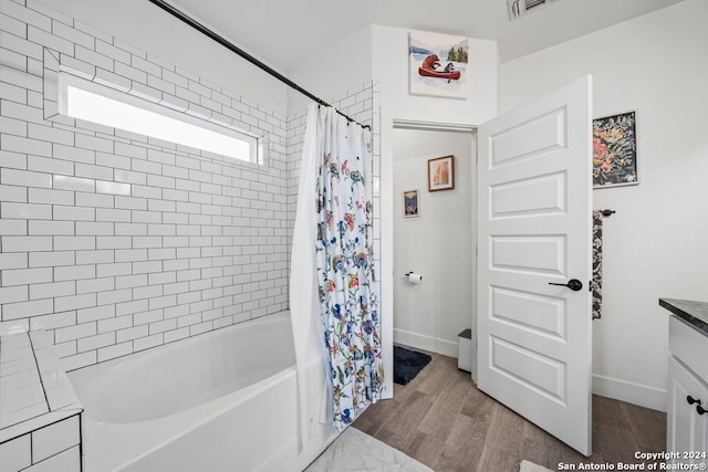 bathroom with vanity, shower / bathtub combination with curtain, and hardwood / wood-style flooring