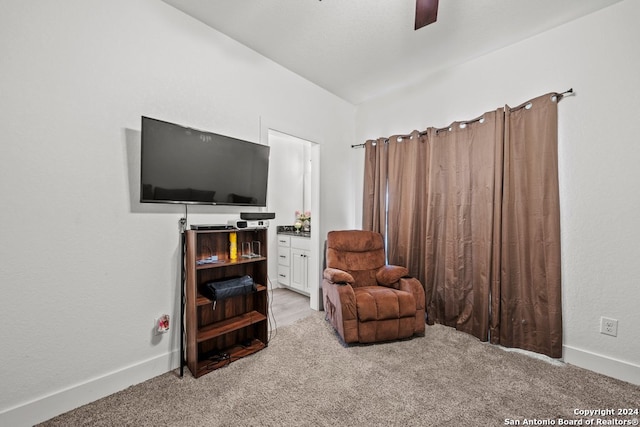 sitting room featuring ceiling fan and light carpet