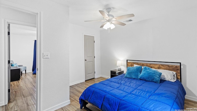 bedroom with ceiling fan and light hardwood / wood-style flooring