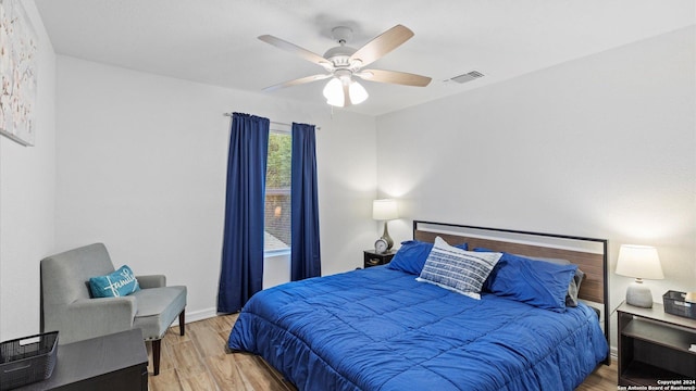 bedroom with ceiling fan and light wood-type flooring