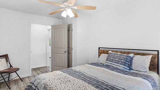 bedroom with ceiling fan and light hardwood / wood-style flooring