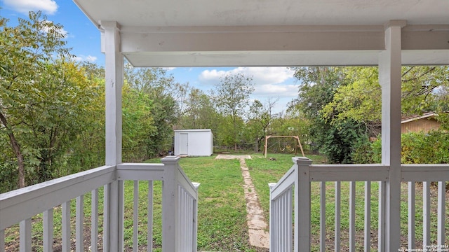 view of yard featuring a playground and a storage unit