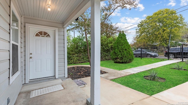 property entrance featuring a lawn