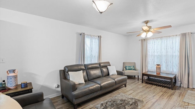 living room featuring light hardwood / wood-style floors and ceiling fan