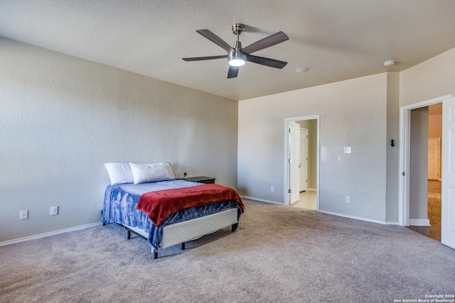 bedroom with ceiling fan and light colored carpet