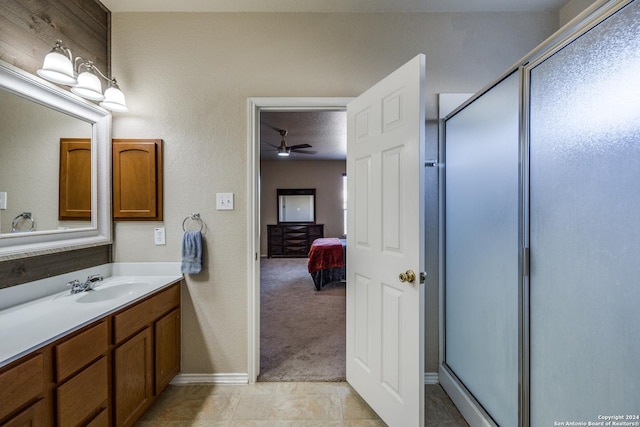 bathroom with tile patterned flooring, vanity, an enclosed shower, and ceiling fan