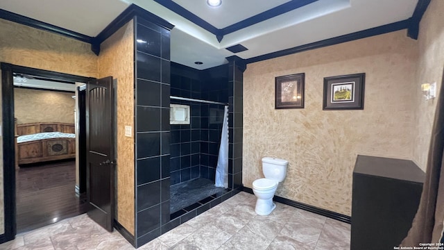 bathroom with a tile shower, hardwood / wood-style flooring, toilet, and crown molding