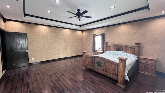 bedroom with a tray ceiling, ceiling fan, and dark hardwood / wood-style floors