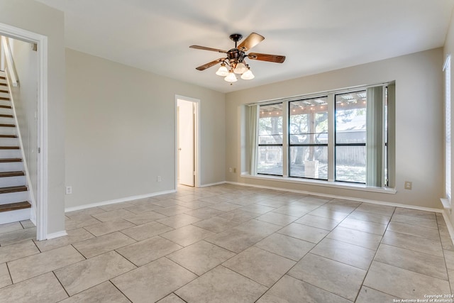 empty room featuring ceiling fan and light tile patterned flooring