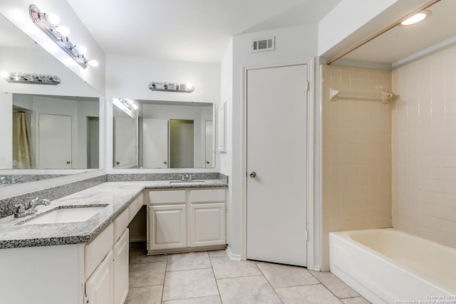 bathroom with vanity, tile patterned floors, and tiled shower / bath combo