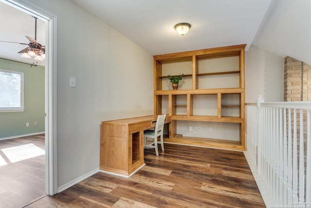 unfurnished office featuring vaulted ceiling, ceiling fan, and dark wood-type flooring