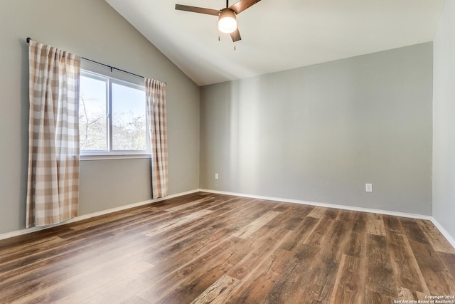 spare room featuring dark hardwood / wood-style floors, ceiling fan, and lofted ceiling