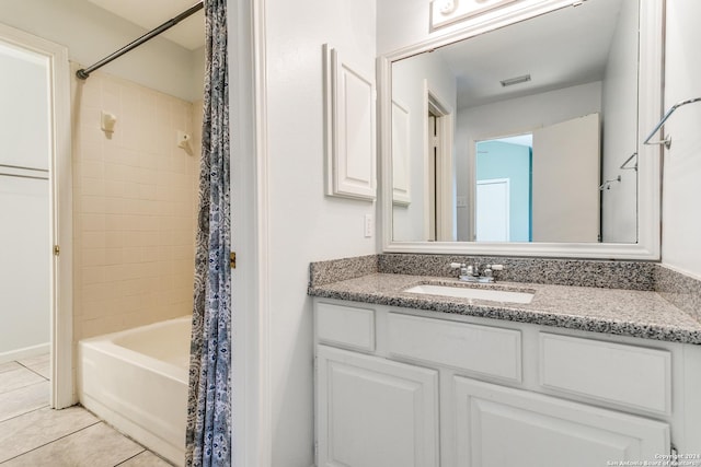 bathroom with tile patterned flooring, shower / bath combination with curtain, and vanity