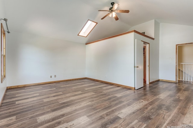 additional living space with ceiling fan, vaulted ceiling with skylight, and dark wood-type flooring