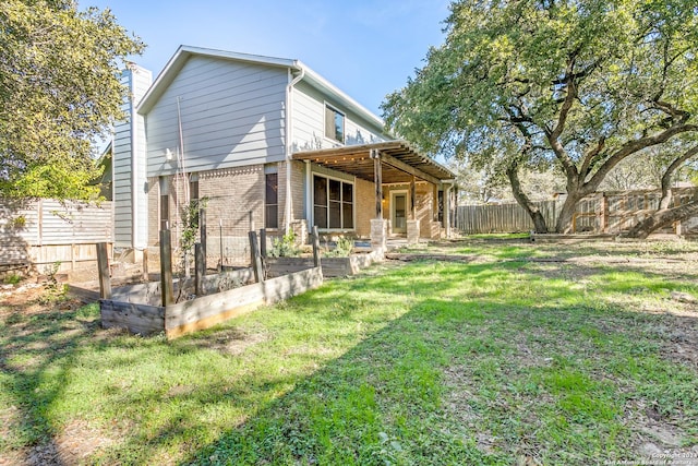 rear view of house featuring a lawn