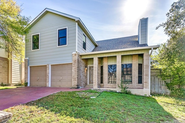 view of front of house with a front yard and a garage