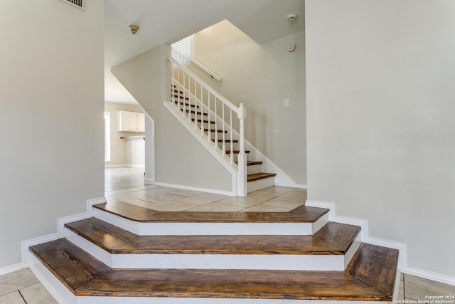 stairs with tile patterned flooring