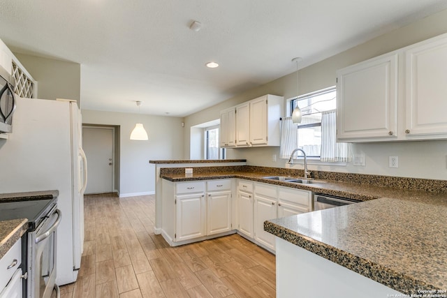 kitchen featuring white cabinets, plenty of natural light, and sink