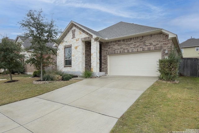 view of front of property with a garage and a front lawn