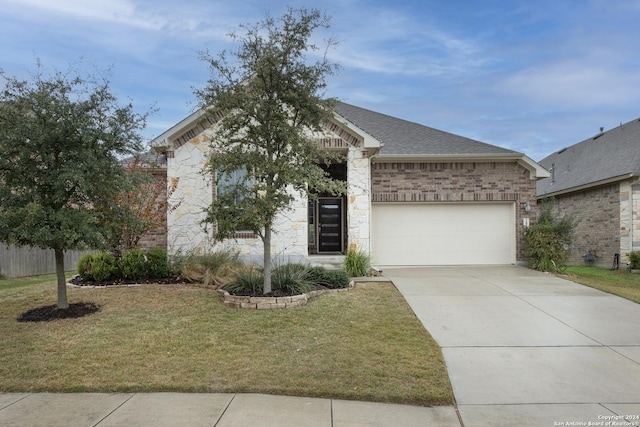 view of front of house featuring a garage and a front lawn