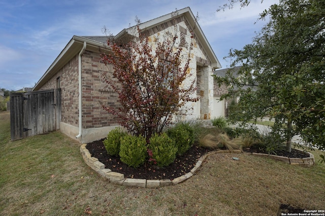 view of property exterior with a lawn