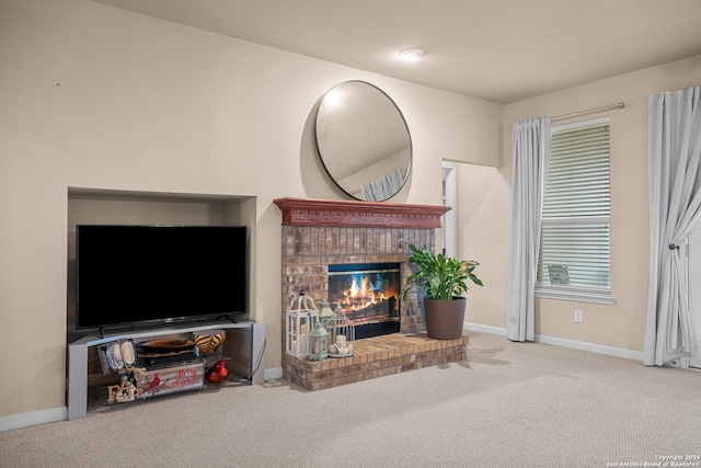 living room featuring carpet and a brick fireplace