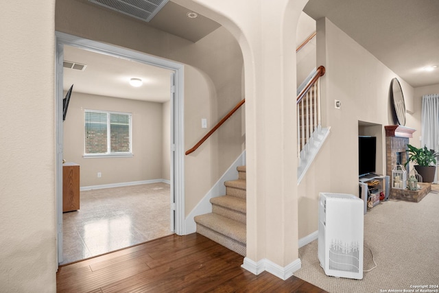 staircase with hardwood / wood-style flooring