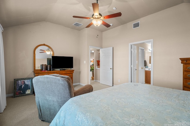 bedroom with light carpet, ensuite bath, vaulted ceiling, and ceiling fan