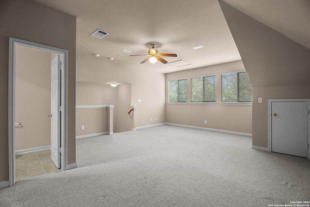 interior space with light carpet, vaulted ceiling, and ceiling fan