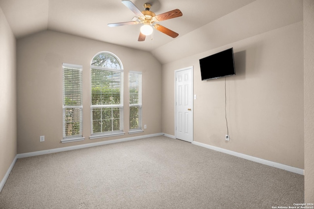 spare room with ceiling fan, carpet floors, and vaulted ceiling