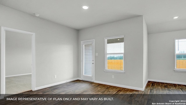 spare room featuring dark wood-type flooring