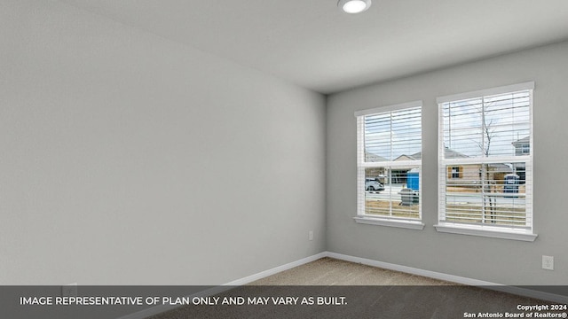 carpeted empty room featuring plenty of natural light