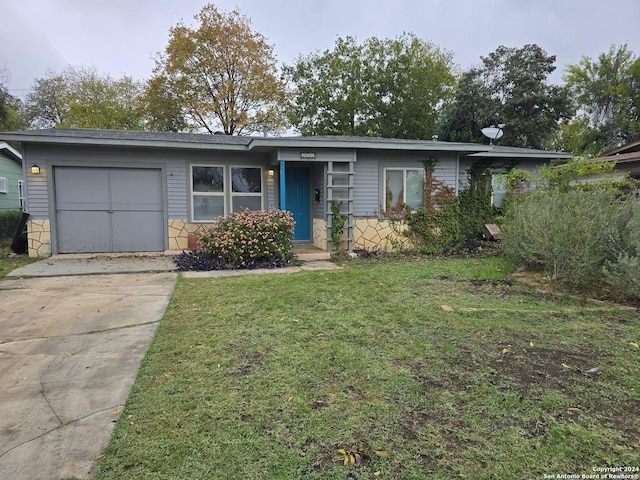 ranch-style house with a front yard and a garage