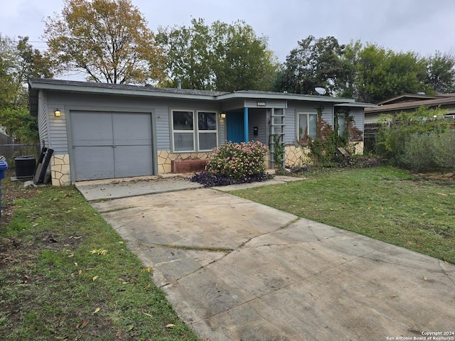 ranch-style home with a garage and a front yard