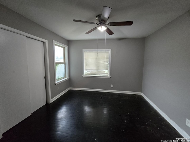 unfurnished bedroom with dark hardwood / wood-style floors and ceiling fan