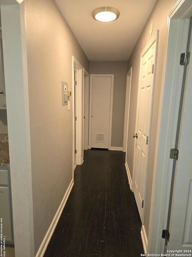 corridor with dark hardwood / wood-style floors