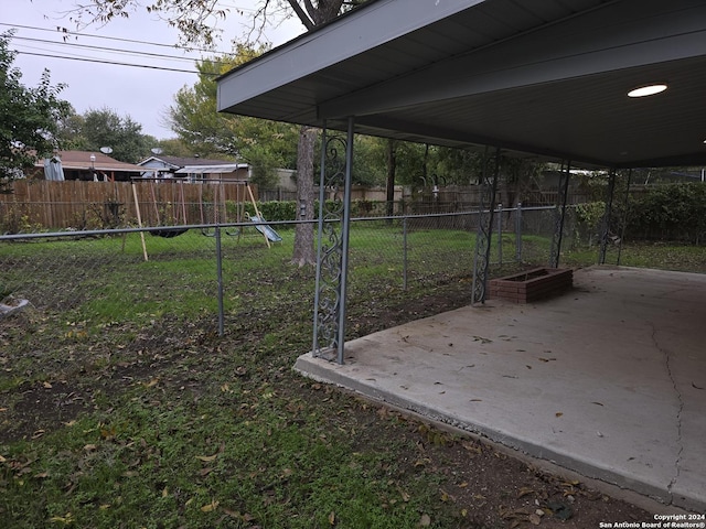 view of yard featuring a playground and a patio