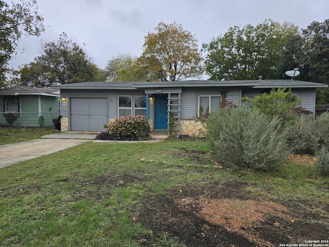 ranch-style home featuring a garage and a front yard