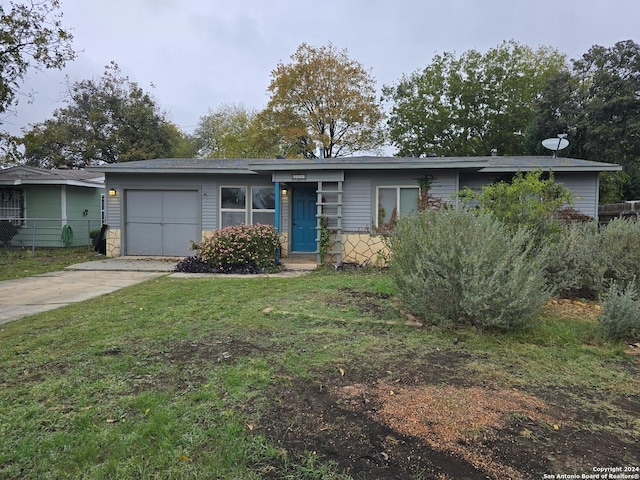 ranch-style house with a garage and a front yard