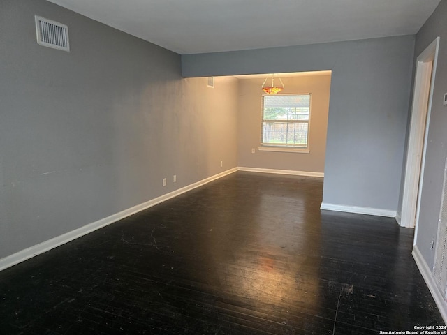 empty room featuring dark wood-type flooring