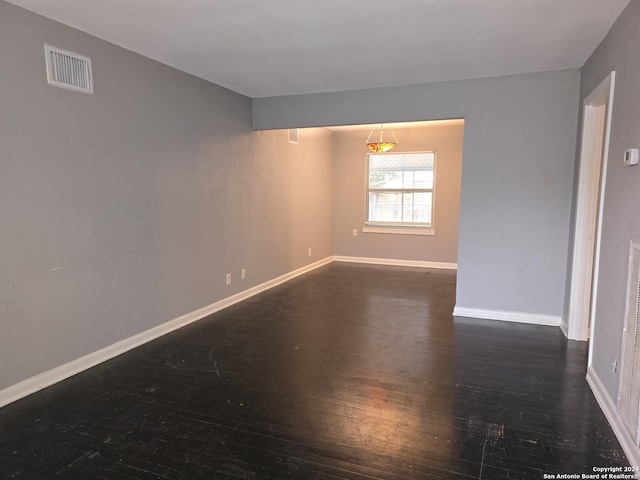 unfurnished room featuring dark wood-type flooring