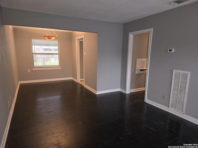 unfurnished room featuring dark wood-type flooring