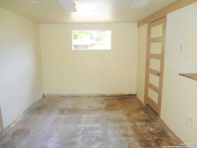 unfurnished room featuring concrete flooring