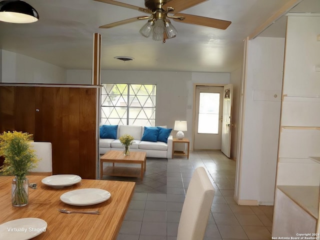 living room with tile patterned flooring and ceiling fan