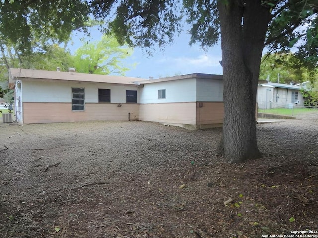 back of house with central AC