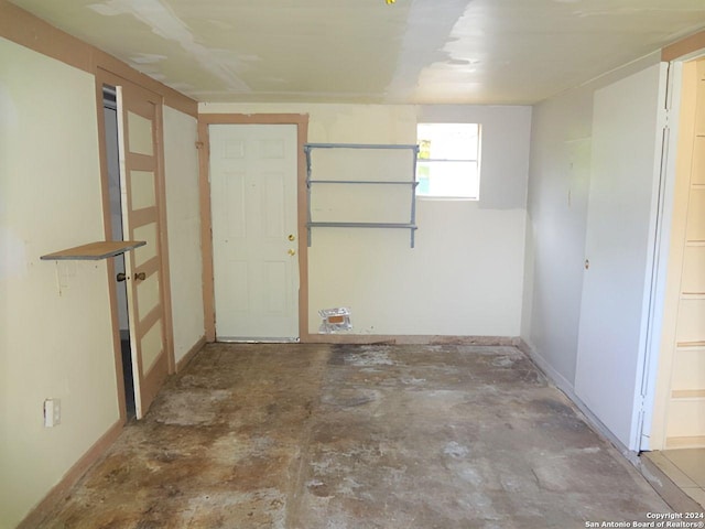 unfurnished room featuring concrete flooring