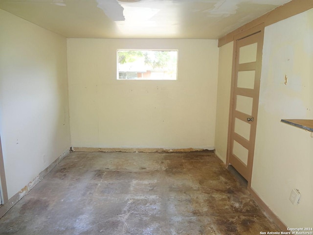 unfurnished room with concrete floors