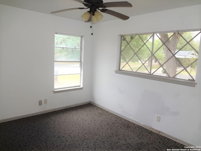 carpeted empty room with ceiling fan